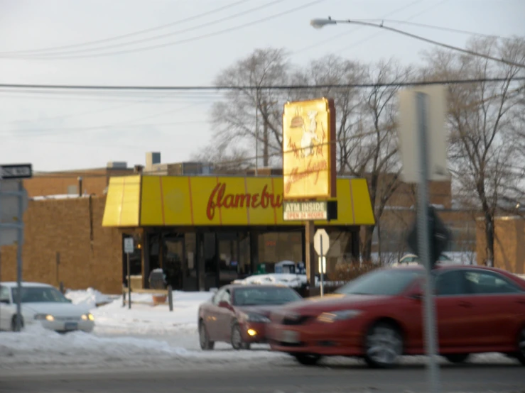 a car passes a gameiro store on the road