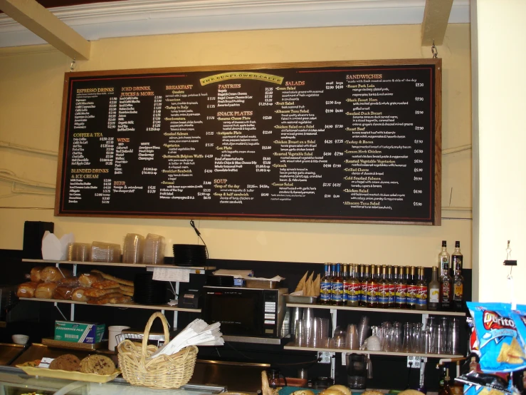 the menu is on a chalkboard in the front of a small eatery