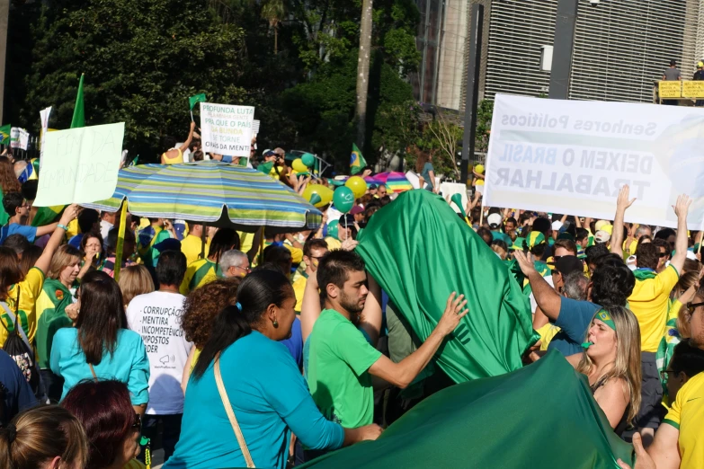 people holding signs and umbrellas with one being carried up