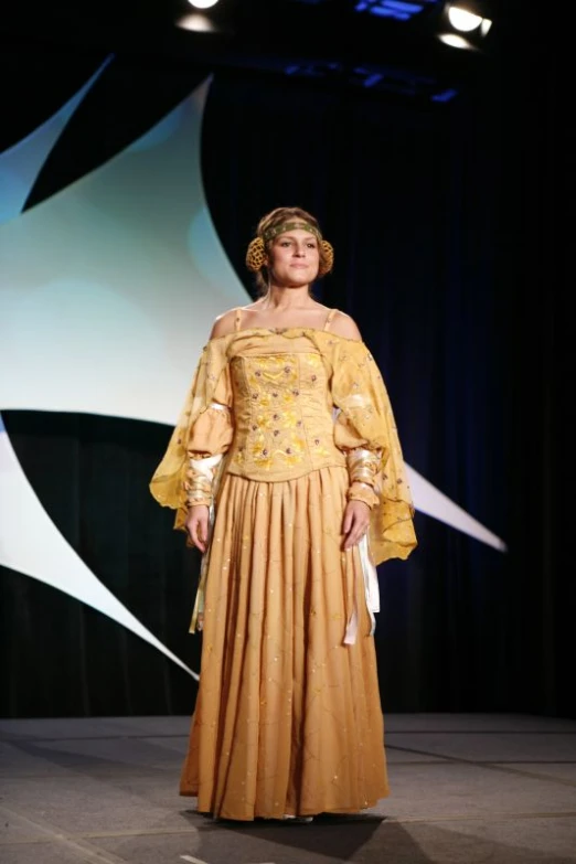 a woman in a long dress on the runway