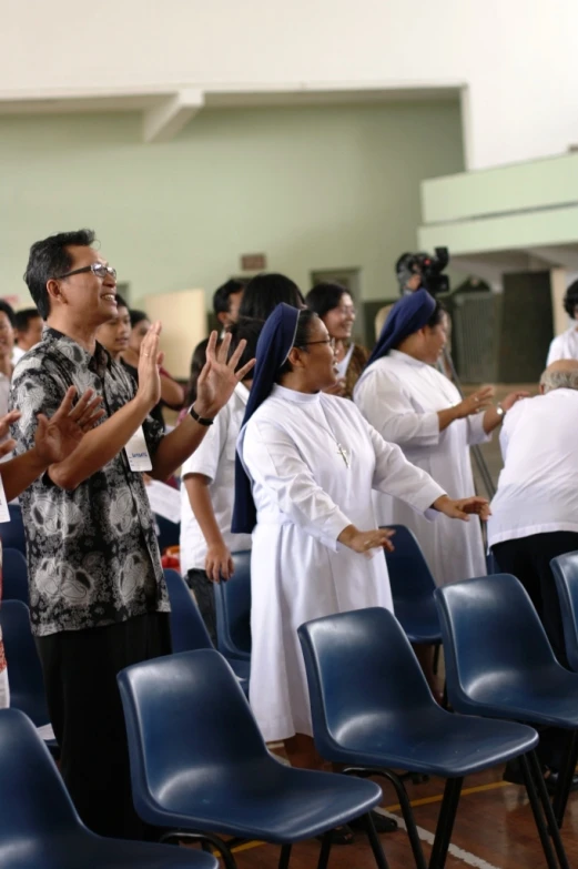 women wearing white and blue dresses on an assembly line