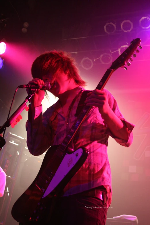 a boy on stage with a guitar