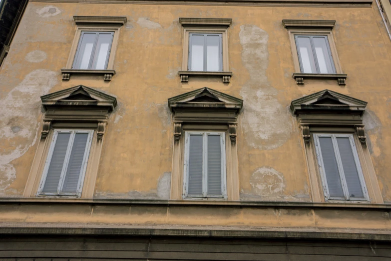 three different windows are displayed on the side of a building