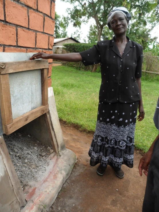 a woman placing cement into the wall and scooping it