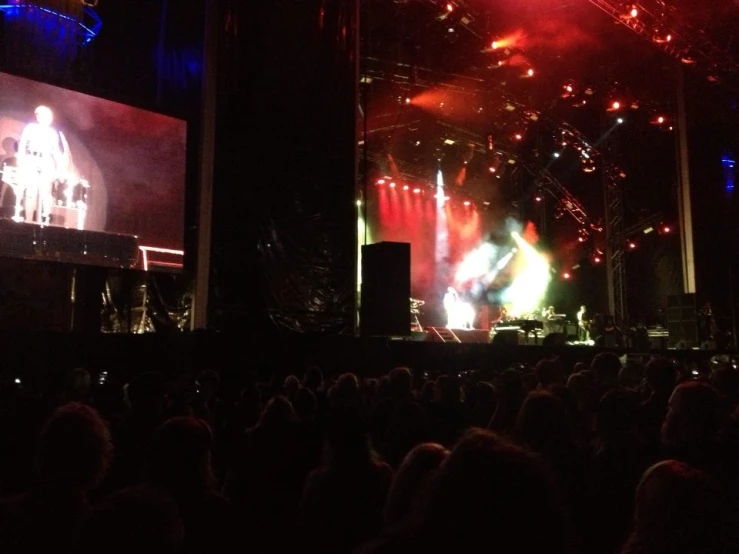 a stage with several lights and people watching