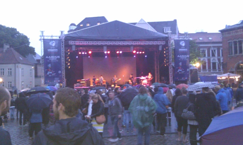 a group of people standing outside with some of them performing