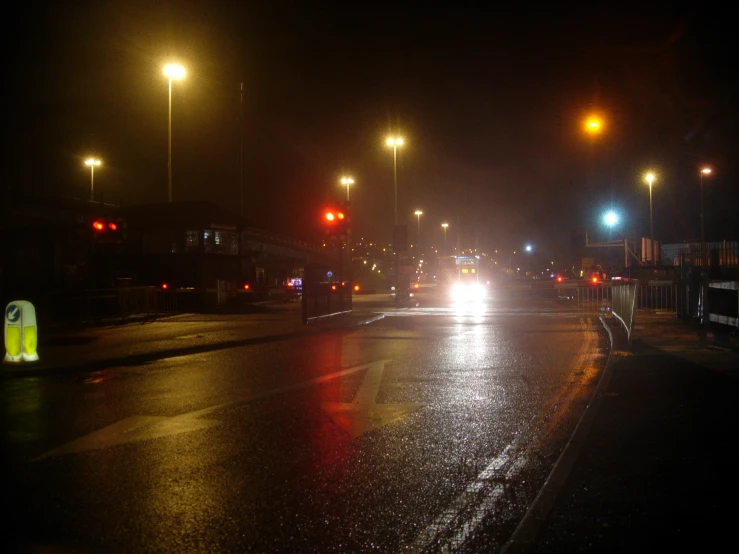 a night view of a street intersection with cars