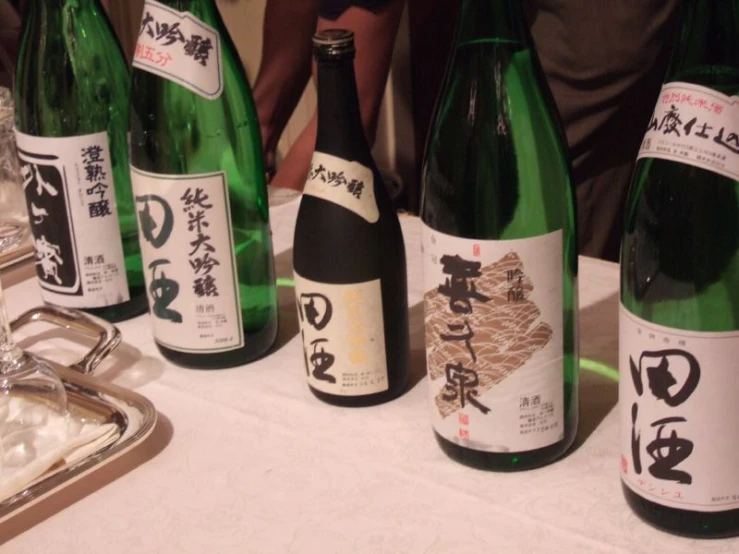 several bottles of wine are lined up at a table