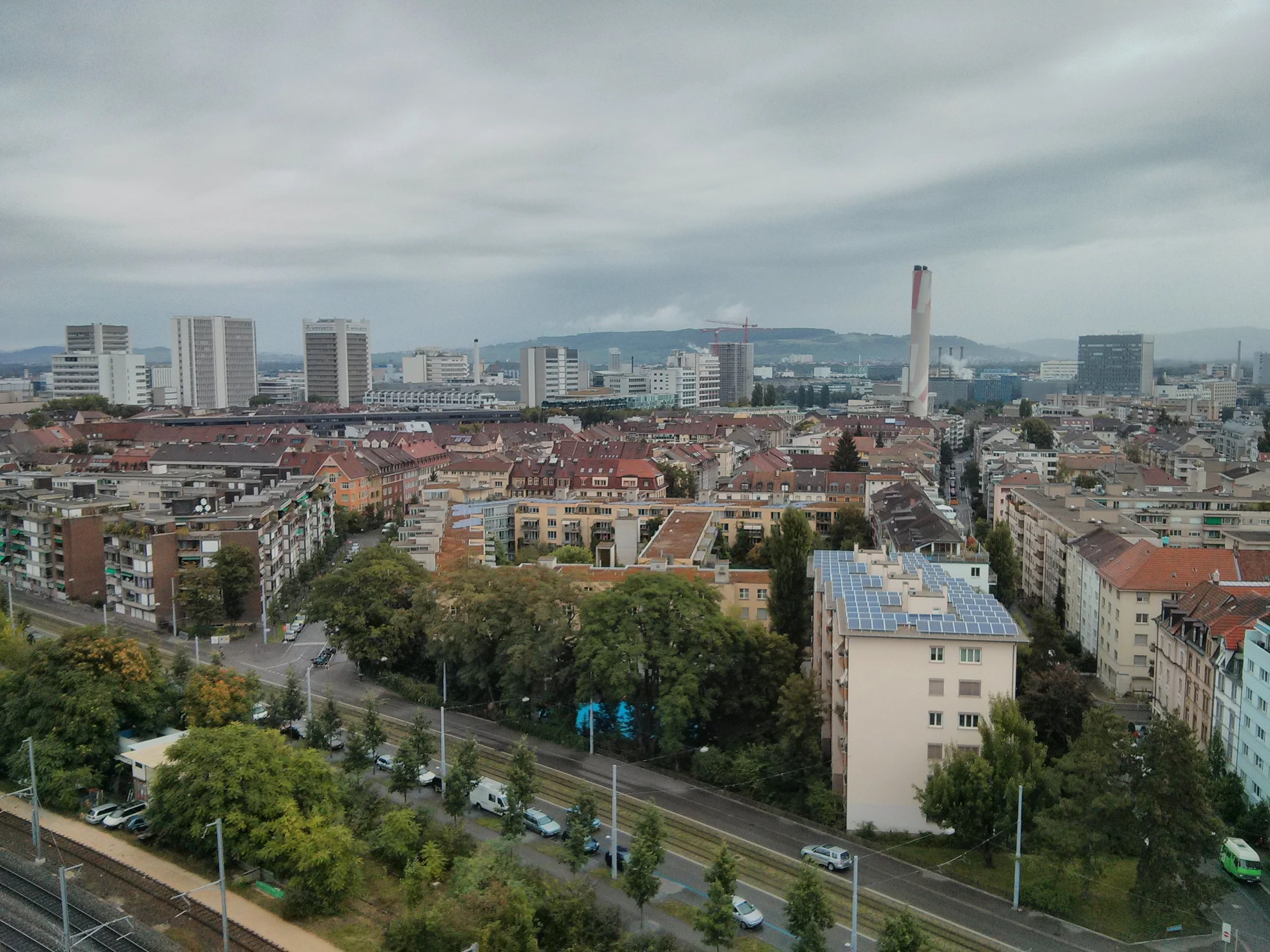 a bird - eye view of a city, with the train tracks in view