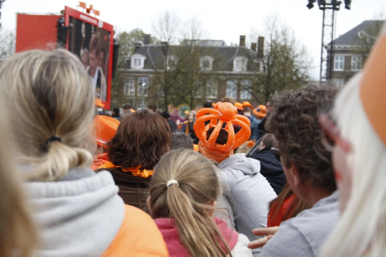 a crowd of people with pumpkins all over them