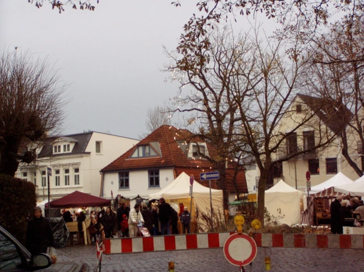 the buildings are behind a barricade with tents