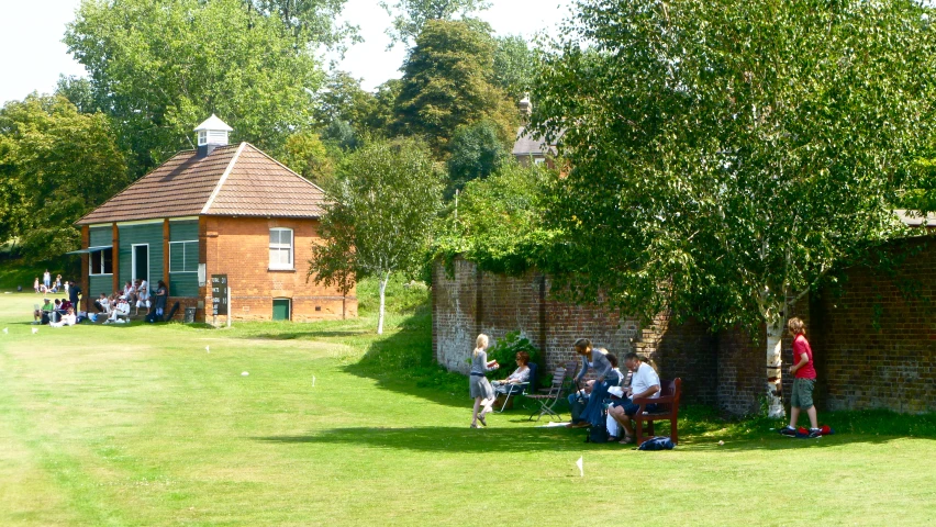 some people sitting on a chair under a tree