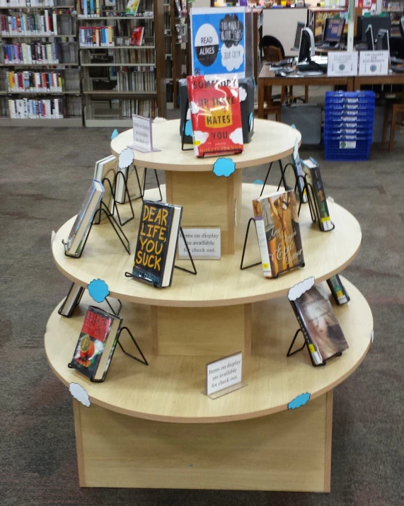 a wooden four tier display in a book store
