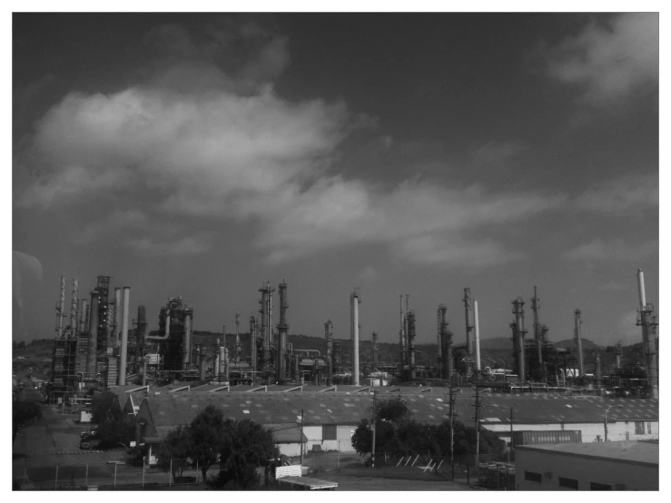 black and white po of factory rooftops and sky