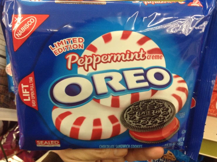 a hand holding up an oreo bag filled with peppermint creme