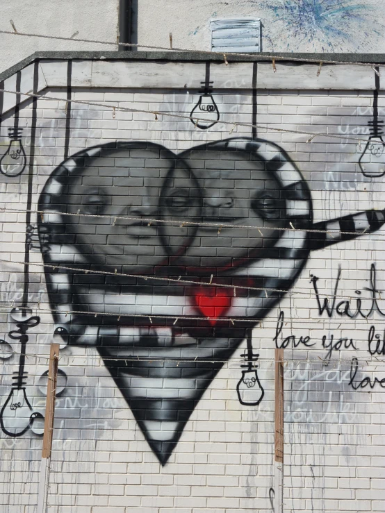 a wall is painted with graffiti and a heart