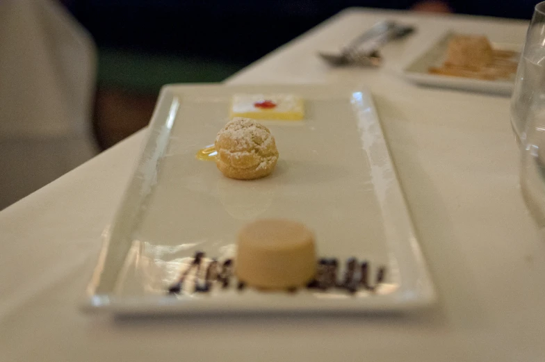 plates with desserts sit on a white table