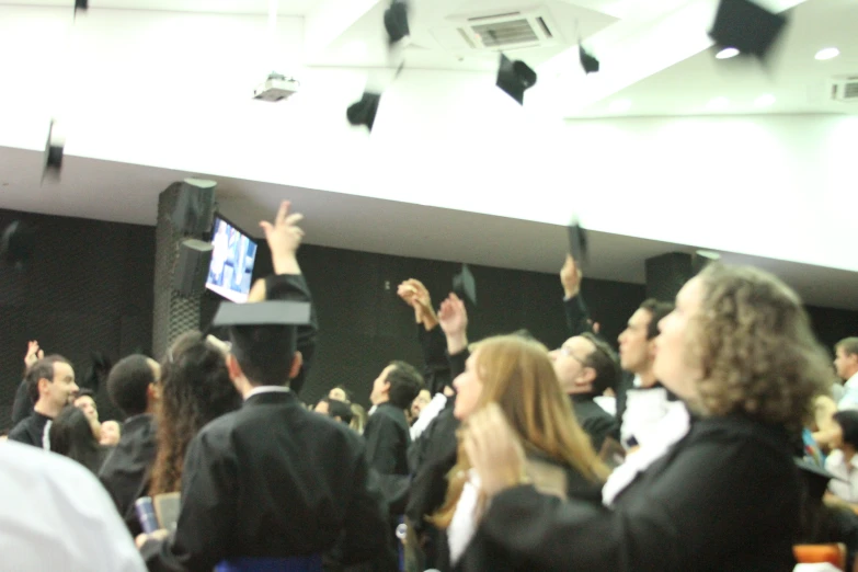 students celeting their graduation with their caps and gowns