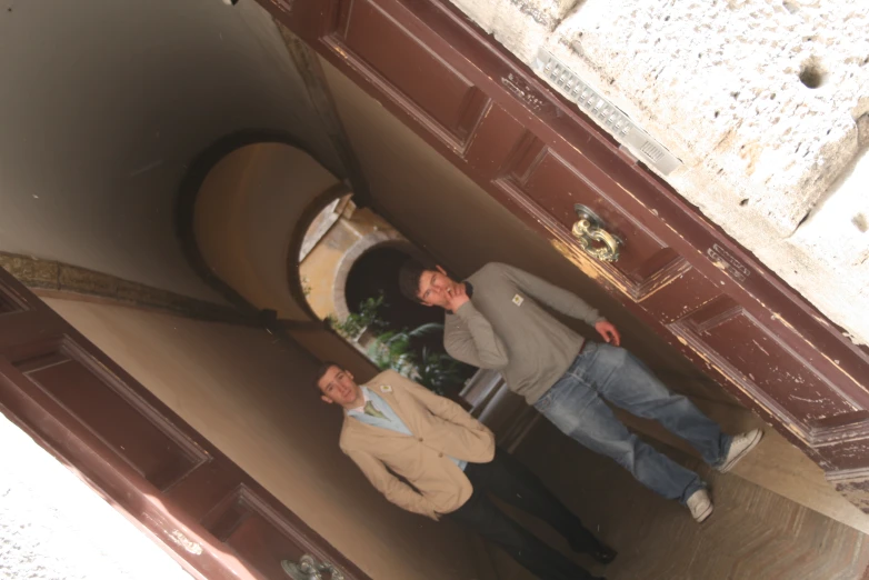 three men standing around a barrel and having their picture taken