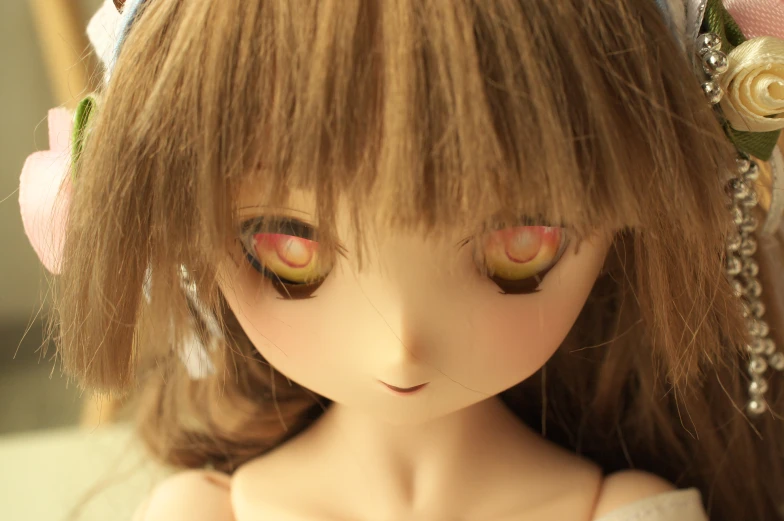 a blonde doll with brown hair and large pink eyes