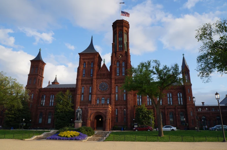 a large brown building with many towers and clocks