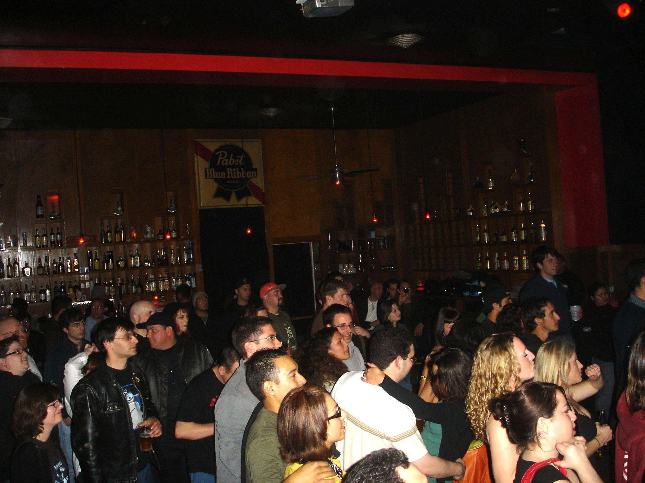 an image of people standing around in a bar