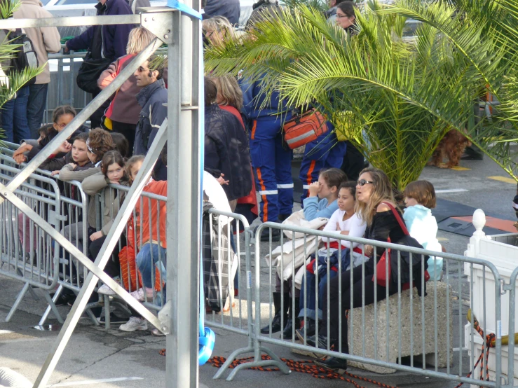 people are sitting inside of a barrier watching soing on a bus