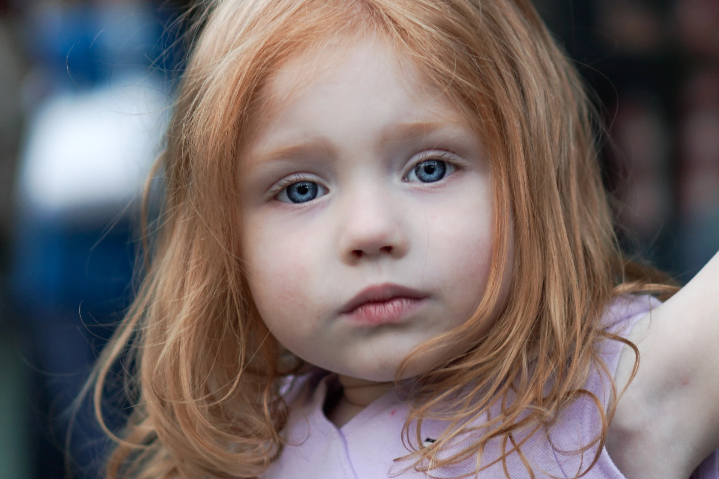 a little girl brushing her hair with a brush