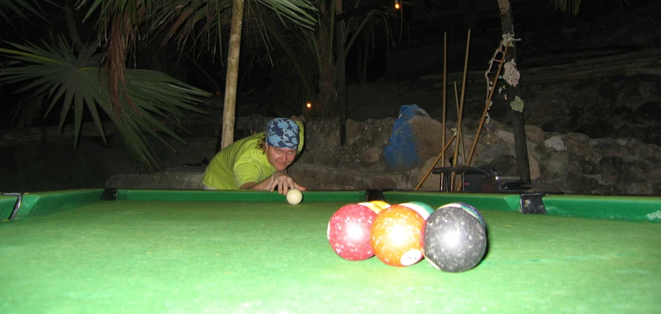a man on a pool table with balls