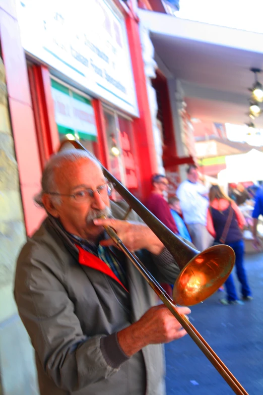 a man drinking from a trumpet in front of a business