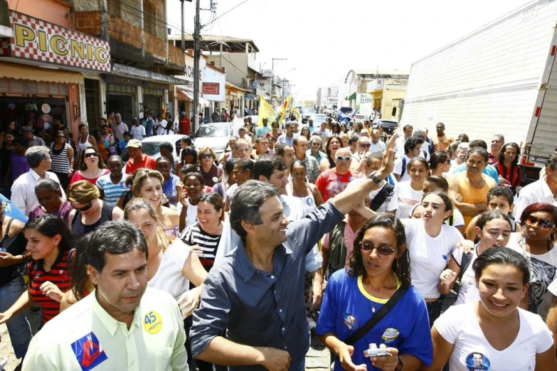 a crowd of people walking down a street in the city