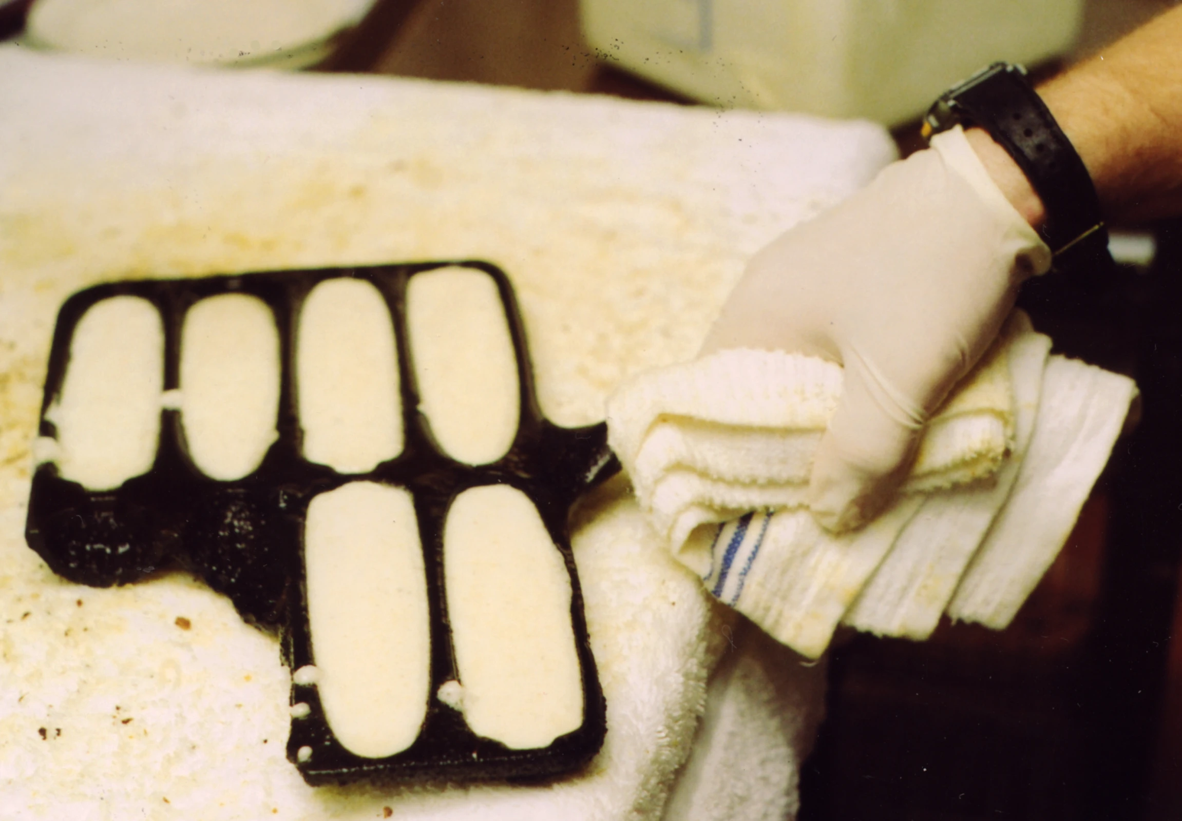 a piece of ice cream in a gloved hand