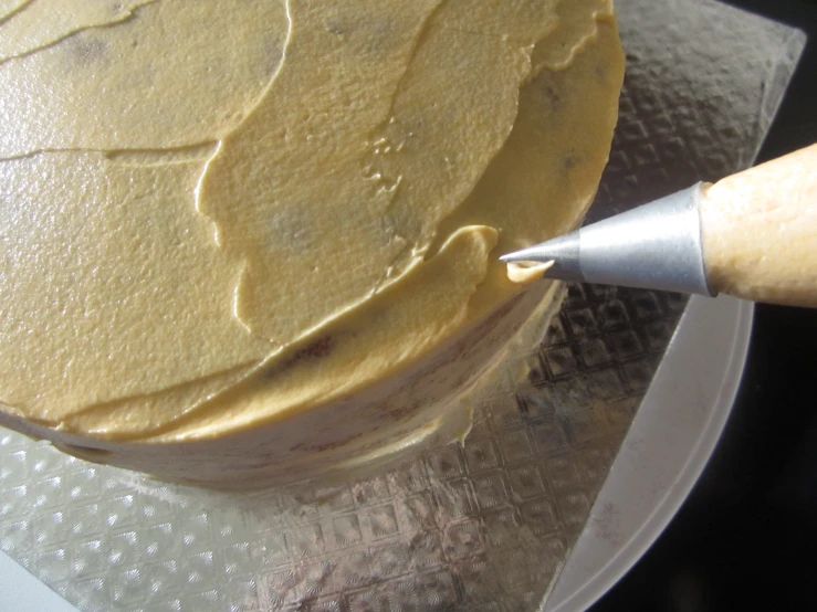 cake with frosting being added to the top
