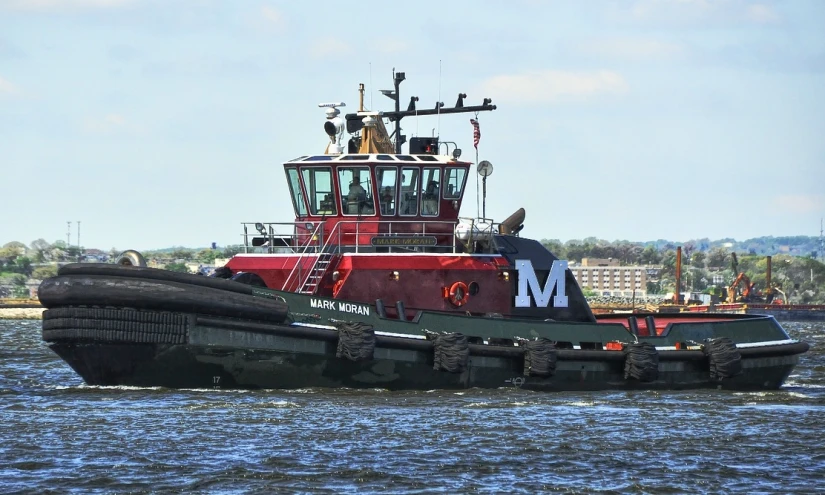 a tug boat is going across the water