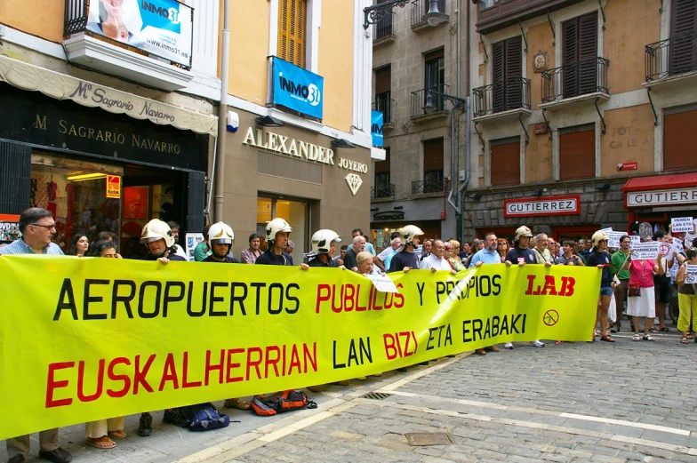 many people with a banner in spanish and some other languages
