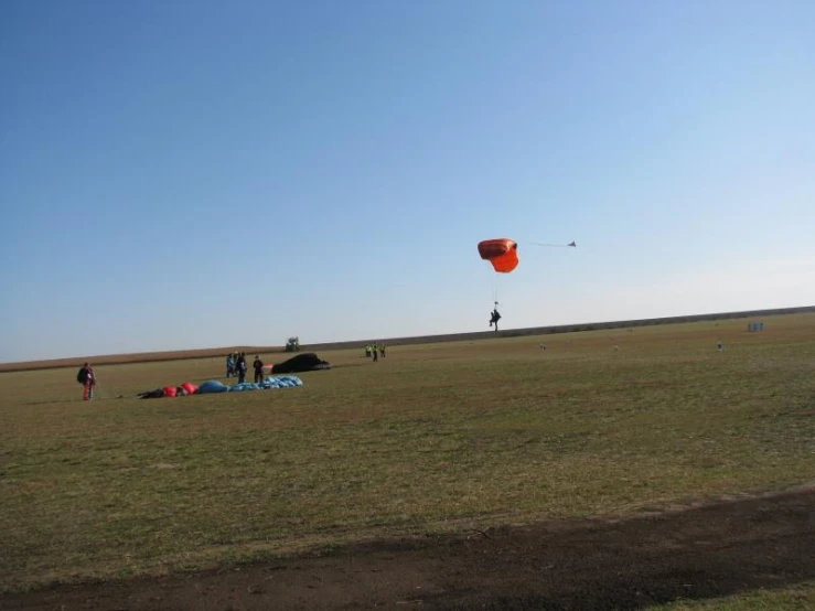 people in a field with a parachute over them