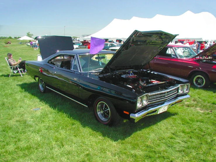 the hood on this classic car is partially closed