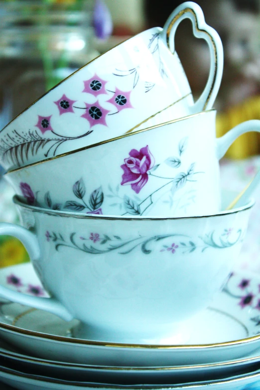 a stack of tea cups and saucers on a table