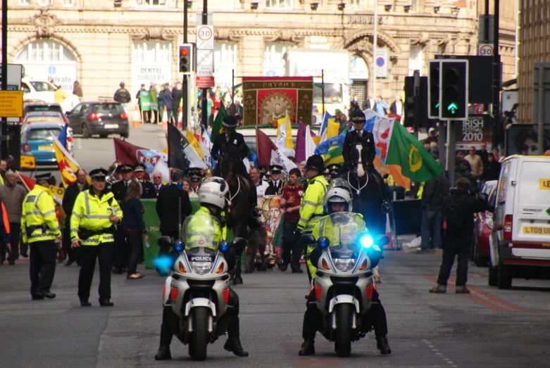 a group of police men riding motorcycles down a street