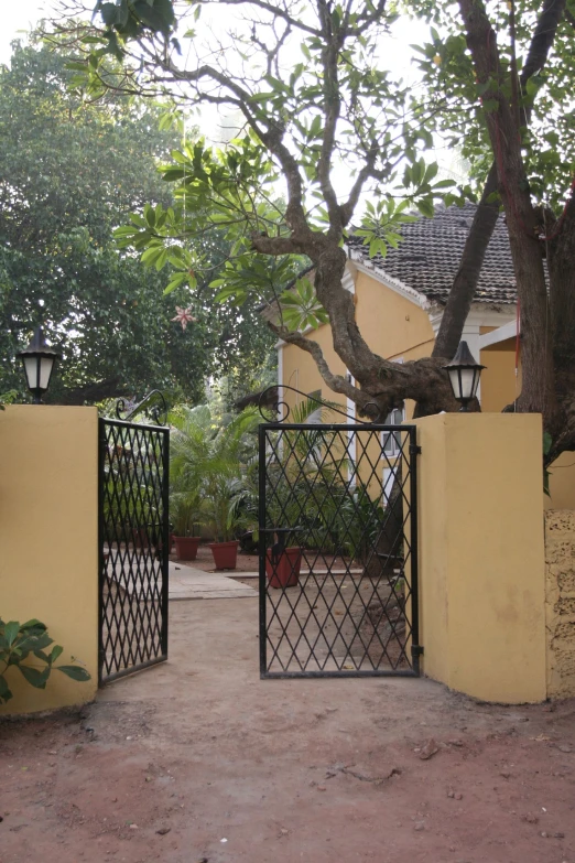 an iron gate in between two buildings