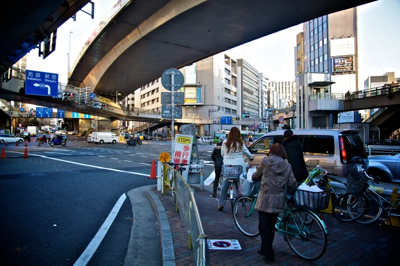 a person walking down a street while another person is riding a bicycle