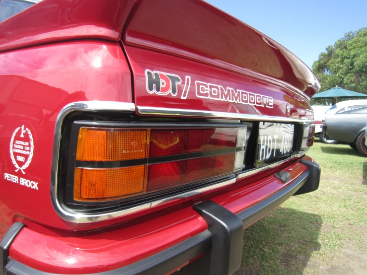 a car taillight sits in the grass on a sunny day