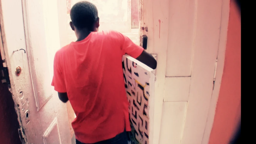 man looking at a sign in a door way