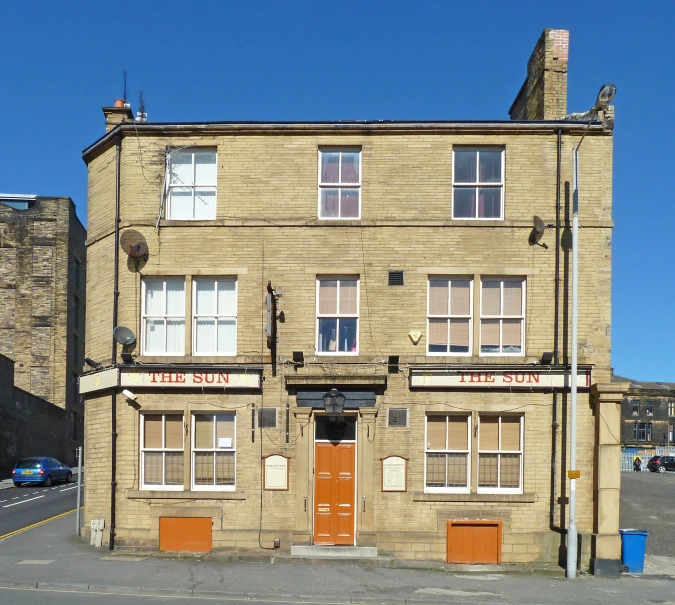 the old building has a clock displayed on the side of it