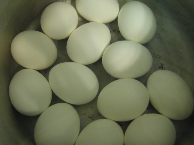 some eggs are in a pot being cooked