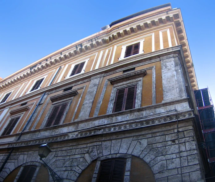 the view up at a building with open window shutters