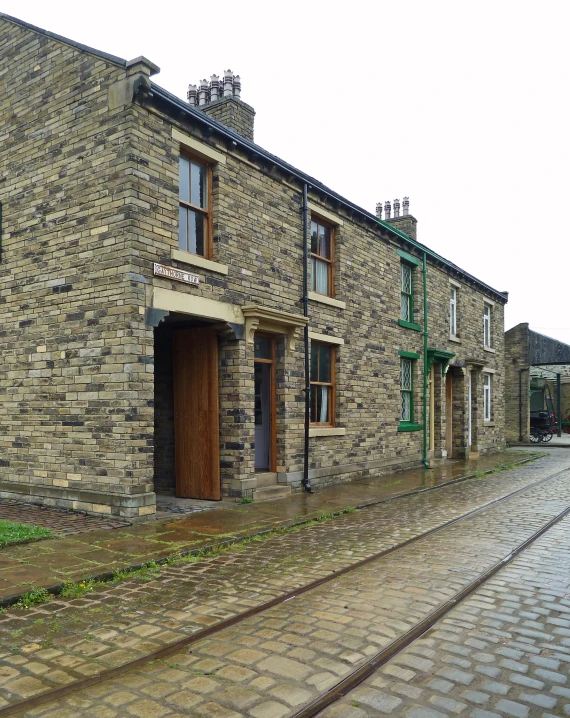 two brick buildings near one another on a cobblestone street