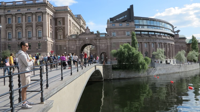 a group of people standing on the side of a river