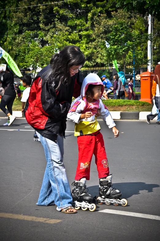 a woman teaching a child how to skate