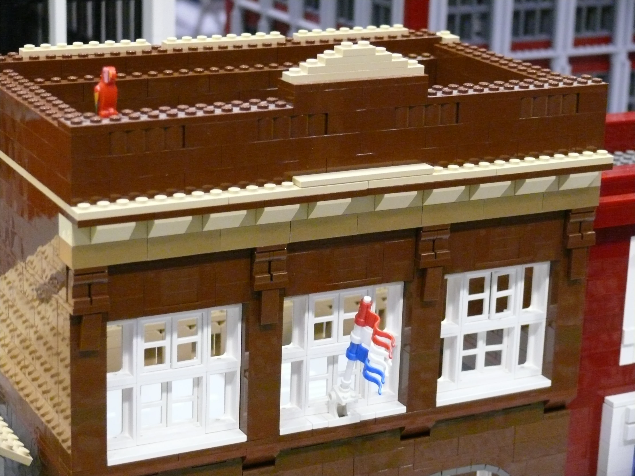 a very large lego building set with people on the roof